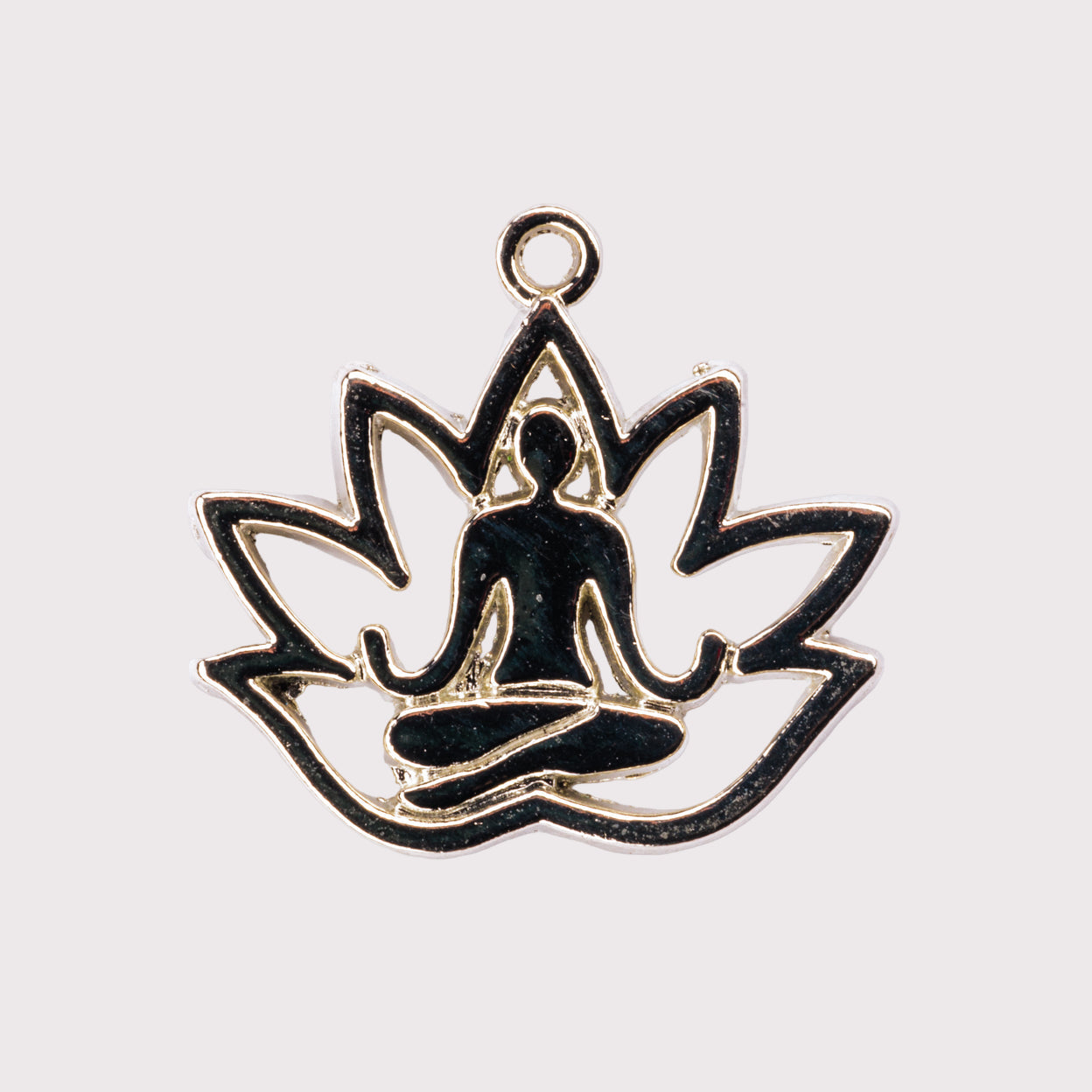 A charm with a design of a person in a meditation pose sitting inside a lotus flower shape, predominantly gold with black detailing.