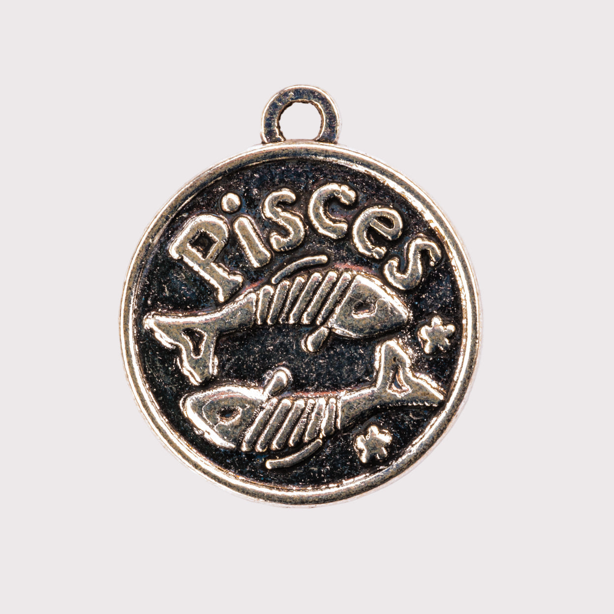 Pisces zodiac charm with fish illustration on a white background